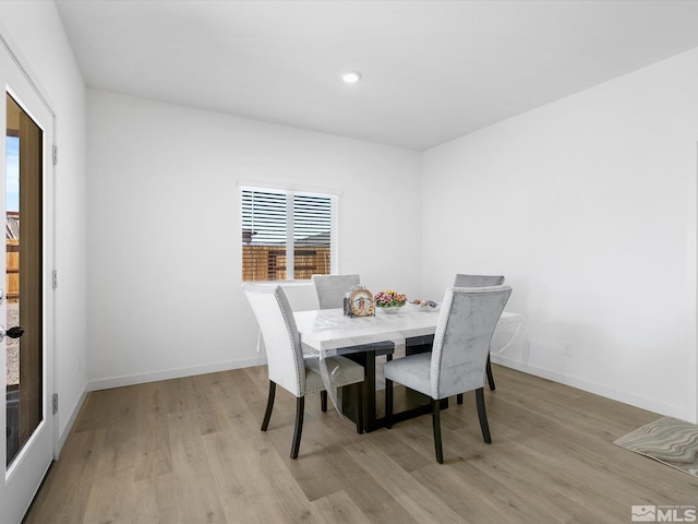 dining room featuring recessed lighting, light wood-style flooring, and baseboards