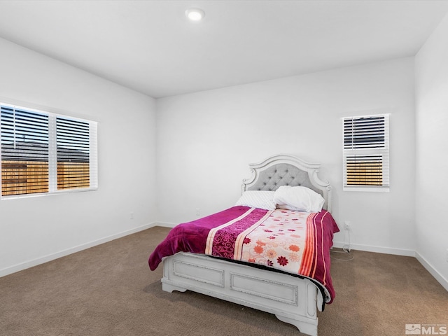 bedroom with carpet and baseboards