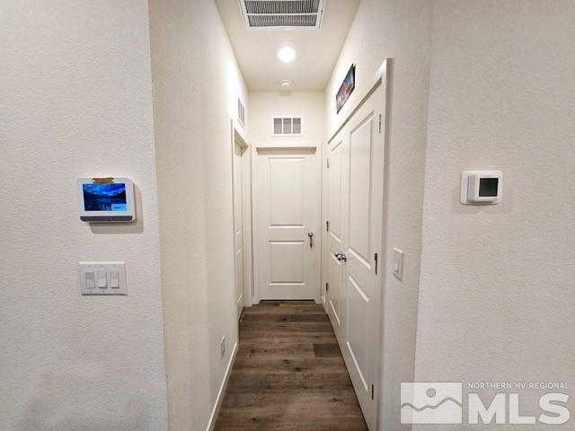 hallway featuring dark hardwood / wood-style flooring