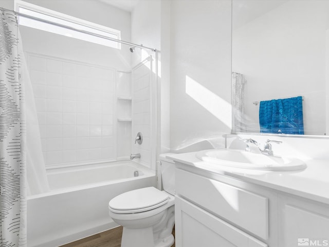 full bathroom featuring wood finished floors, shower / tub combo, toilet, and vanity