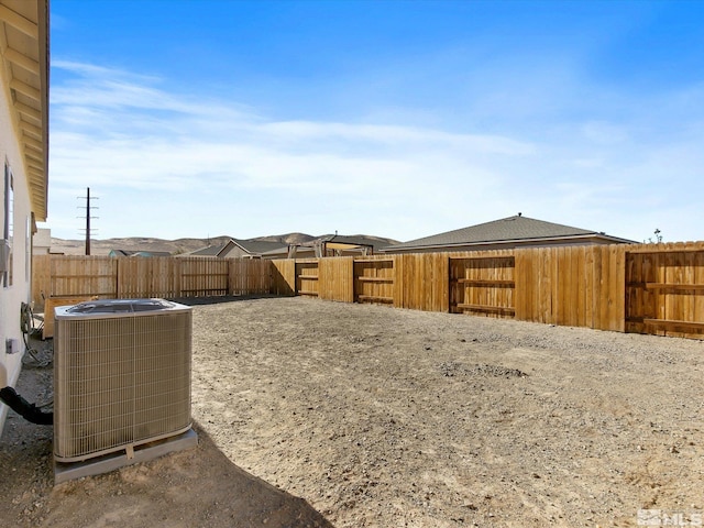 view of yard featuring a fenced backyard and central AC unit