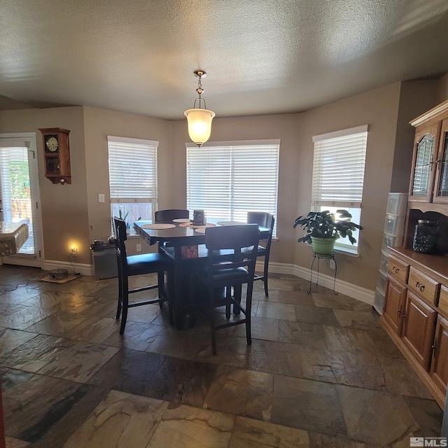 dining room featuring a textured ceiling