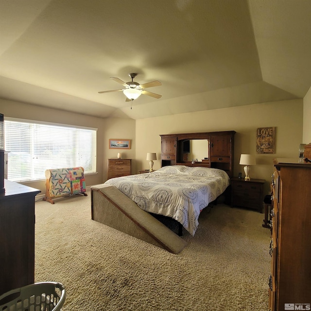 bedroom with lofted ceiling, ceiling fan, and carpet