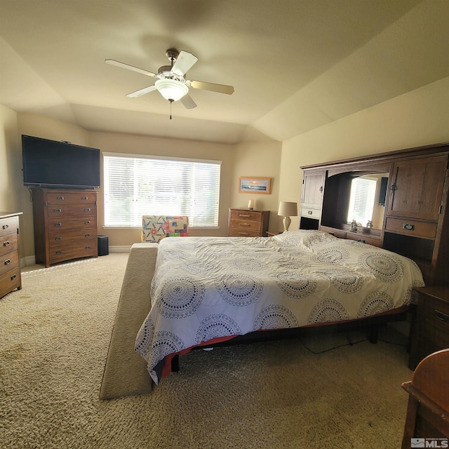 carpeted bedroom with vaulted ceiling and ceiling fan