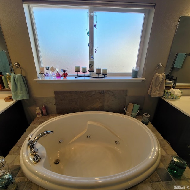 bathroom with vanity and a tub