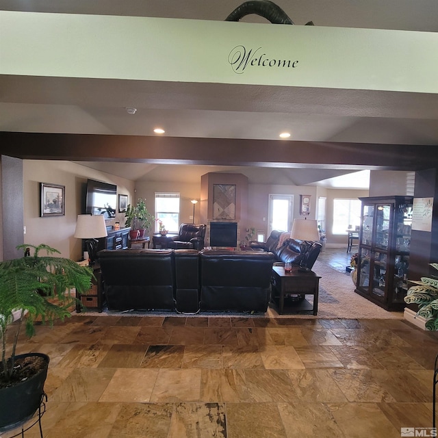 living room featuring lofted ceiling with beams