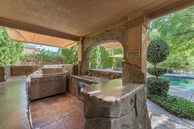 view of patio / terrace featuring sink and exterior kitchen