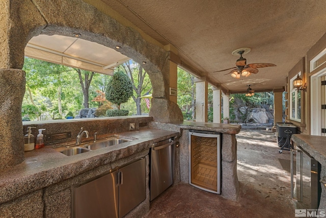 view of patio / terrace with area for grilling, ceiling fan, wine cooler, and sink