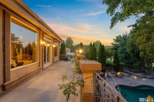 view of patio terrace at dusk