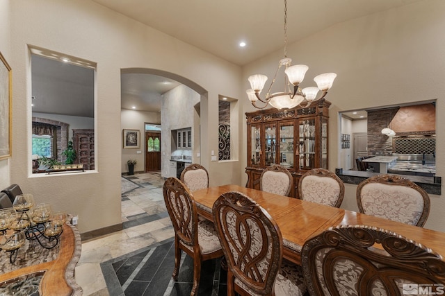 dining room featuring a chandelier and vaulted ceiling