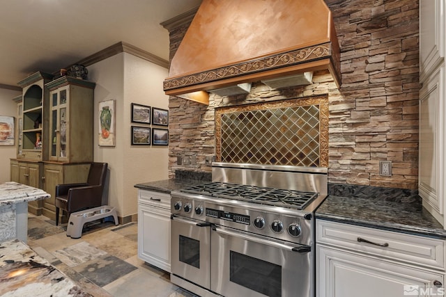 kitchen featuring double oven range, crown molding, premium range hood, and white cabinetry