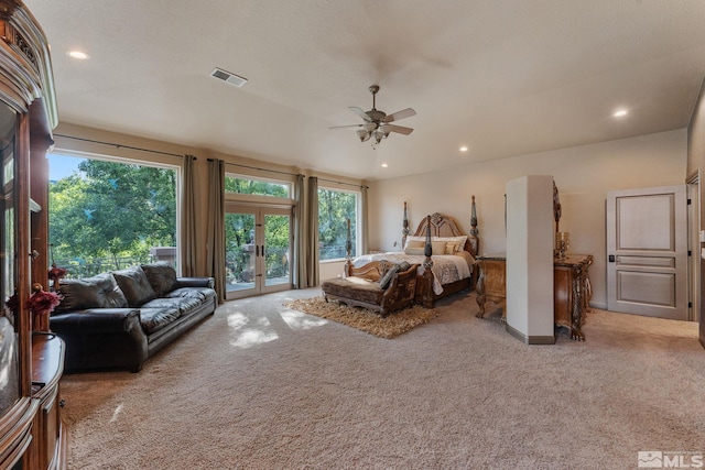 bedroom featuring a textured ceiling, light colored carpet, access to outside, ceiling fan, and french doors