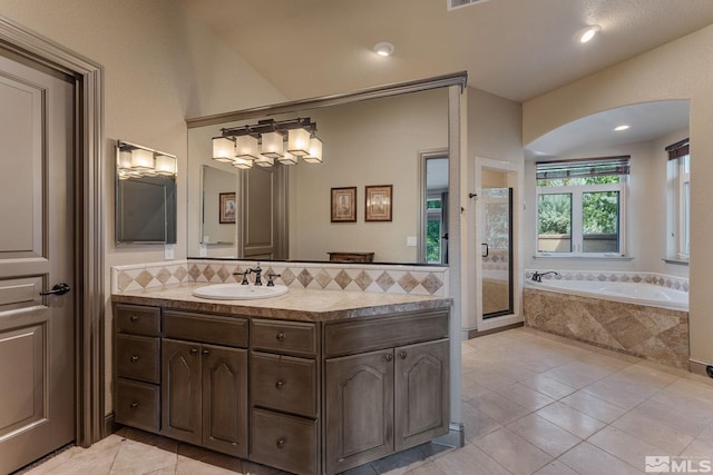 bathroom featuring tile patterned floors, vanity, and separate shower and tub