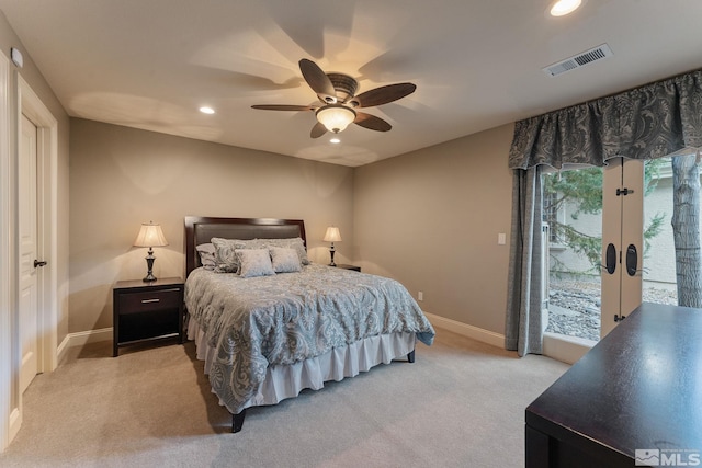 bedroom with light carpet, ceiling fan, and french doors