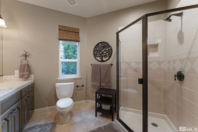 bathroom with vanity, toilet, tile patterned floors, and an enclosed shower