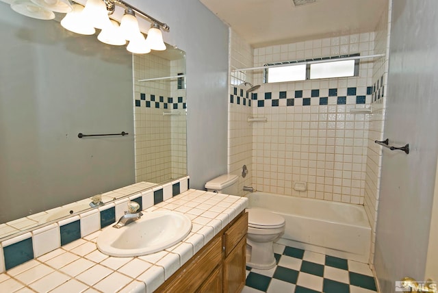 full bathroom featuring tiled shower / bath, vanity, toilet, and tasteful backsplash