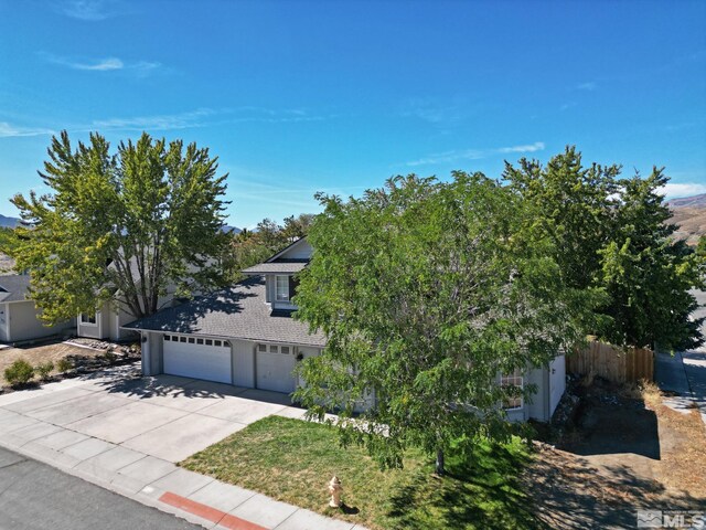 obstructed view of property with a garage