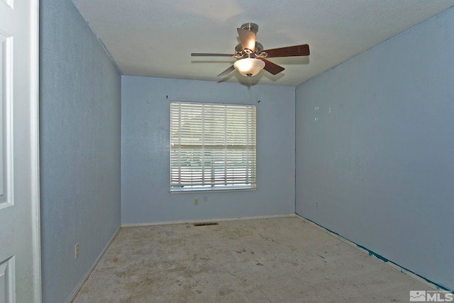 carpeted spare room with ceiling fan