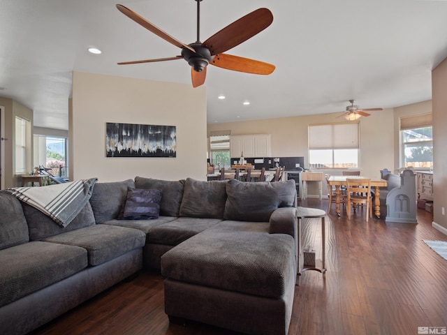 living room with dark hardwood / wood-style floors and ceiling fan