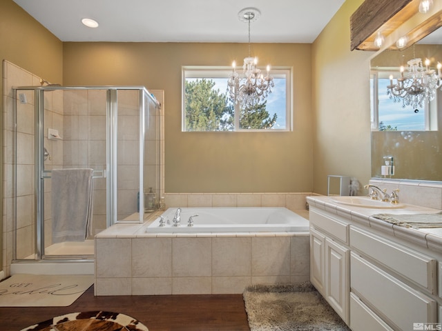 bathroom with vanity, plus walk in shower, a chandelier, and hardwood / wood-style flooring