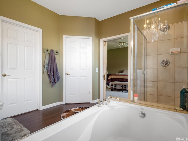 bathroom with independent shower and bath, hardwood / wood-style flooring, and ceiling fan