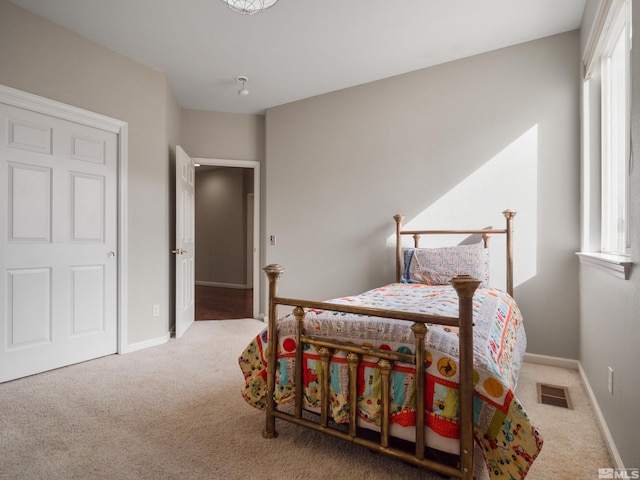 bedroom with multiple windows and carpet flooring