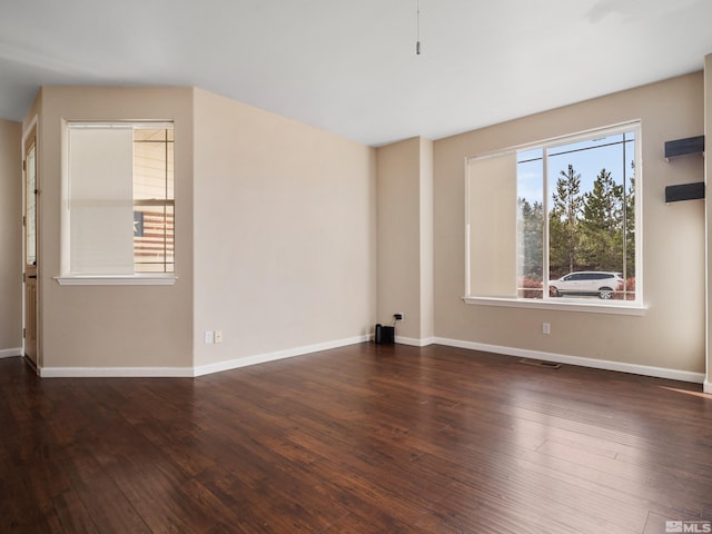 spare room with dark hardwood / wood-style flooring