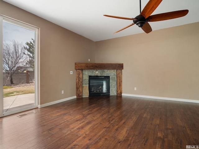 unfurnished living room with ceiling fan and dark hardwood / wood-style floors