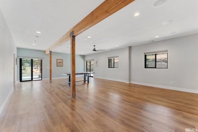 interior space featuring baseboards, beamed ceiling, light wood-style floors, and recessed lighting