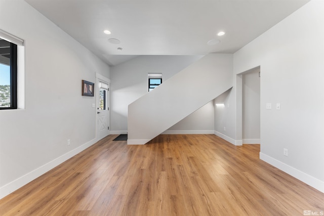 unfurnished living room with baseboards, light wood-style floors, and recessed lighting