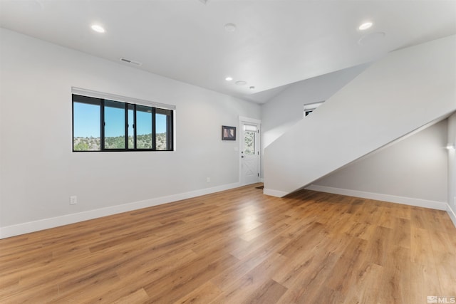 unfurnished living room with baseboards, light wood-style floors, and visible vents
