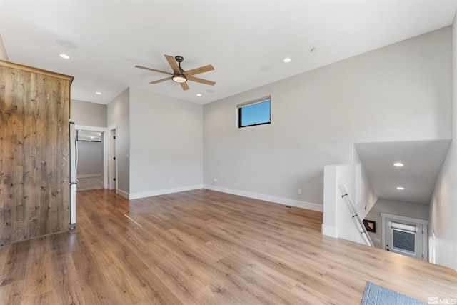 unfurnished living room with baseboards, wood finished floors, recessed lighting, and a ceiling fan