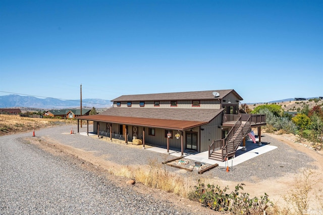 exterior space with a deck with mountain view