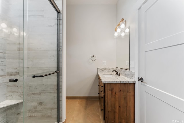 bathroom with vanity, baseboards, and a shower stall