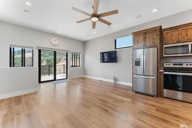 kitchen featuring baseboards, ceiling fan, recessed lighting, appliances with stainless steel finishes, and light wood-style floors
