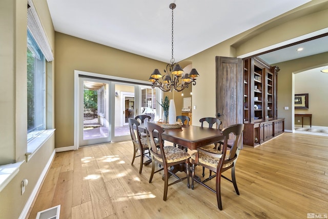 dining area featuring an inviting chandelier and light wood-type flooring