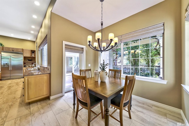 dining room with a chandelier, a healthy amount of sunlight, and sink