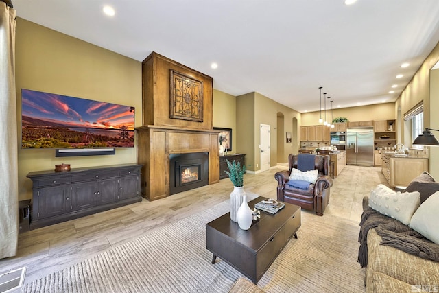 living room featuring a fireplace and sink