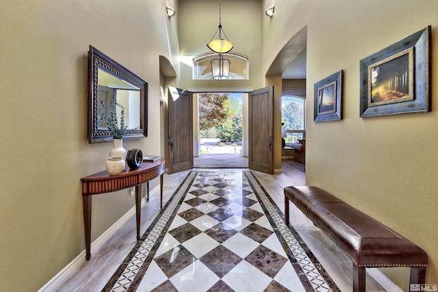 foyer featuring a towering ceiling