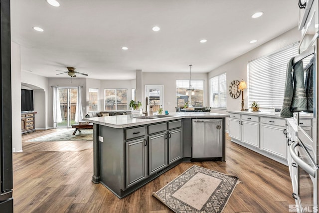 kitchen with ceiling fan, pendant lighting, white cabinets, sink, and appliances with stainless steel finishes