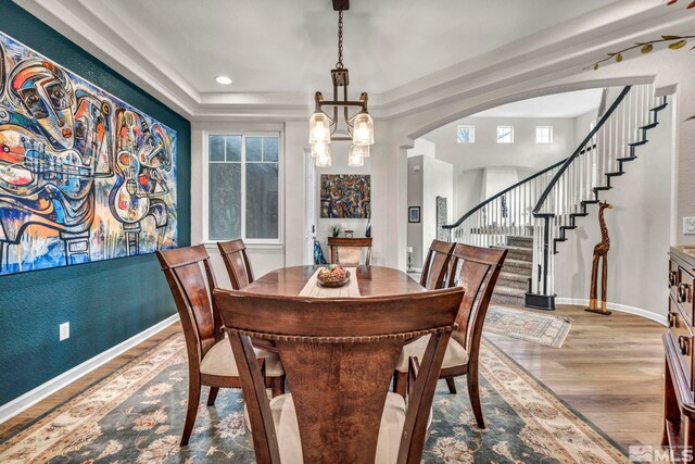 dining area with a notable chandelier and light hardwood / wood-style flooring