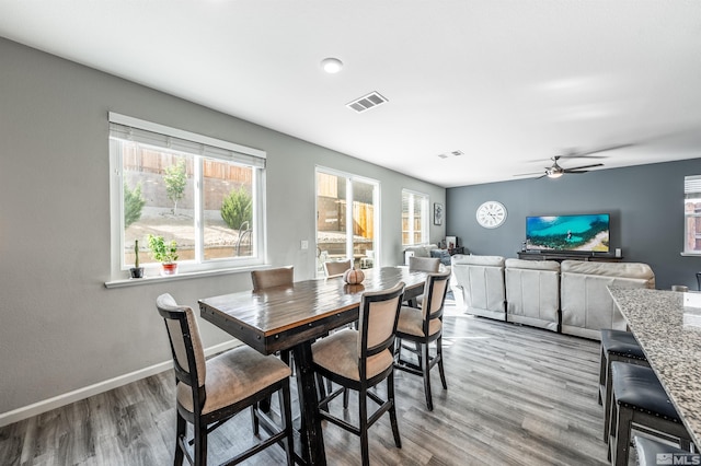 dining room with light hardwood / wood-style floors and ceiling fan