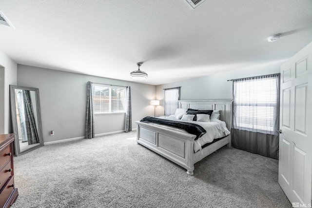 carpeted bedroom featuring ceiling fan and a textured ceiling