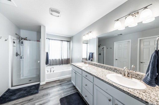 bathroom with vanity, separate shower and tub, and hardwood / wood-style flooring