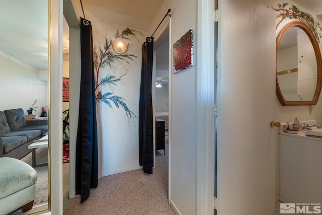 hall with light carpet and ornamental molding