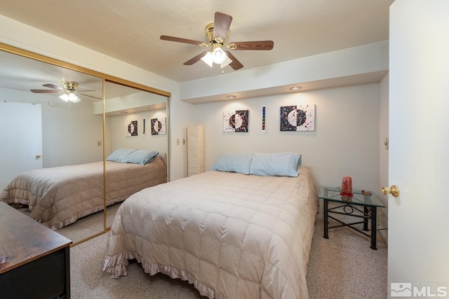 bedroom with ceiling fan, a closet, and carpet