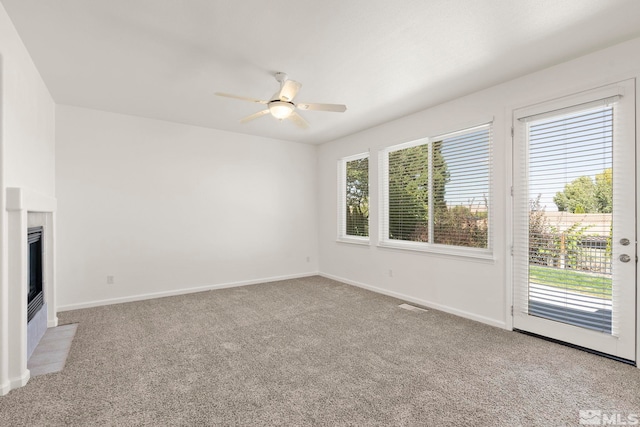 unfurnished living room featuring light carpet and ceiling fan