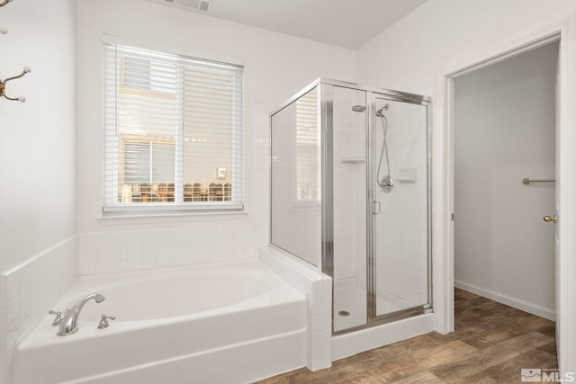 bathroom featuring shower with separate bathtub and hardwood / wood-style flooring