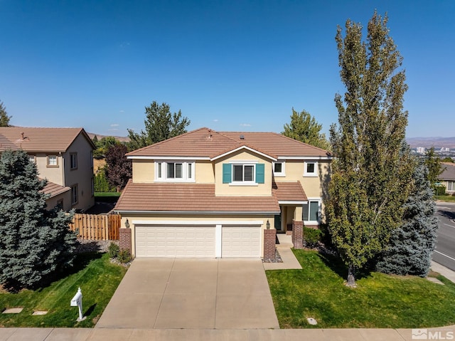 front facade featuring a front lawn and a garage