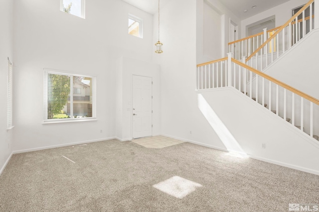 foyer featuring a high ceiling and carpet floors